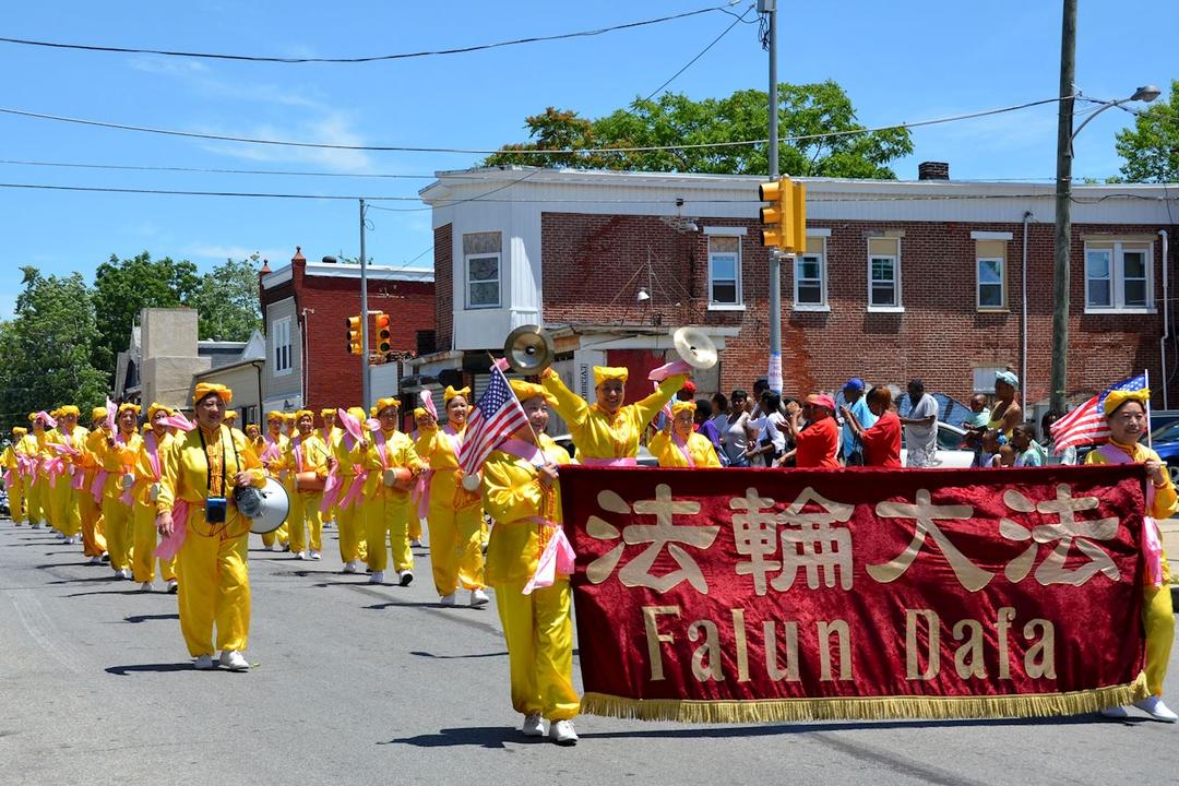 Image for article Chester, Pensilvania: Los practicantes de Falun Dafa tocan los tambores de cintura durante el Desfile del Día del Padre